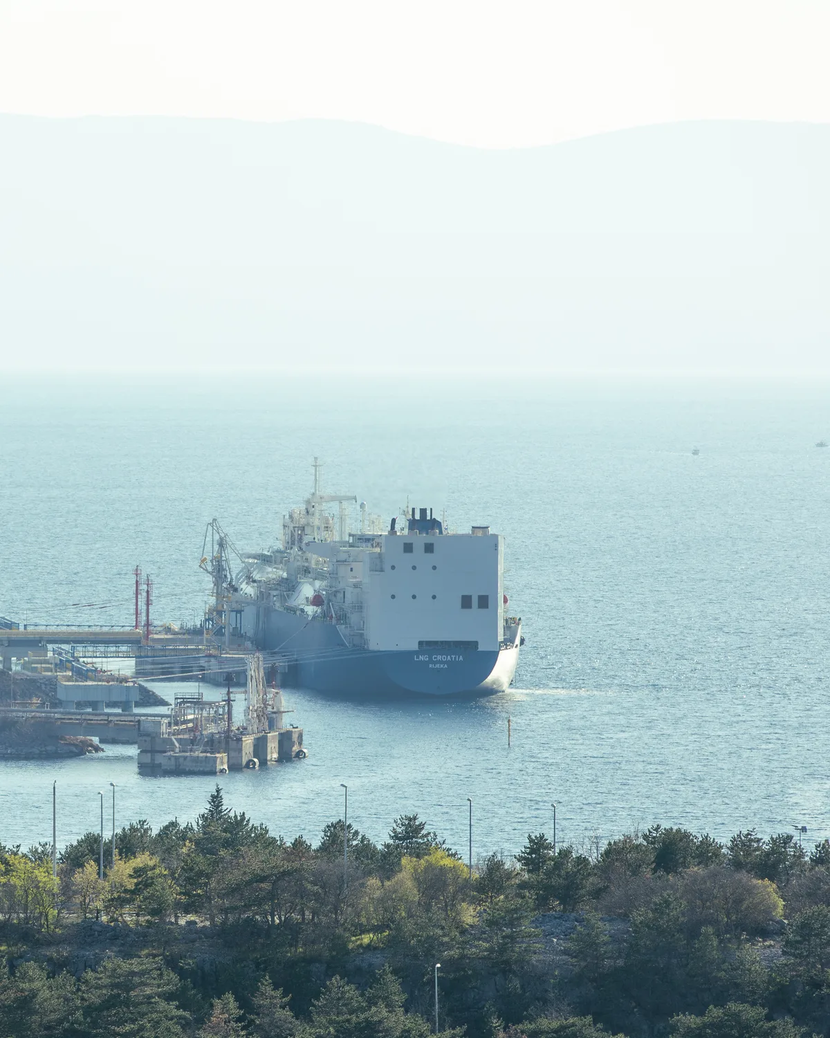 Oil tanker moored at a coastal fuel terminal